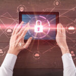 Hand using tablet with network security and online storage system concept