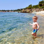 Toddler boy on beach