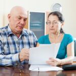 mature man with wife reading  documents