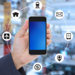 Hand holding blank screen mobile phone on blurred shopping mall background